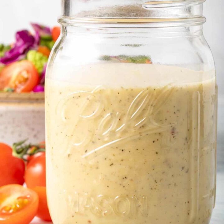 A clear mason jar filled with the best Creamy Vinaigrette.
