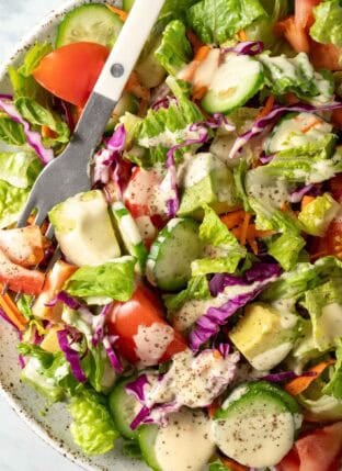 A white plate filled with an easy fresh Garden Salad.