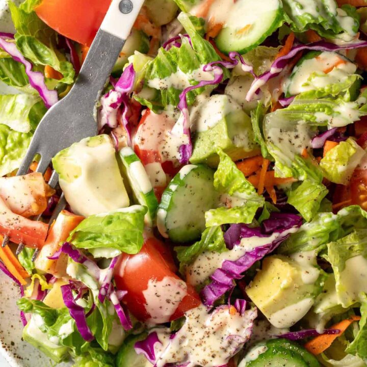 A white plate filled with an easy fresh Garden Salad.
