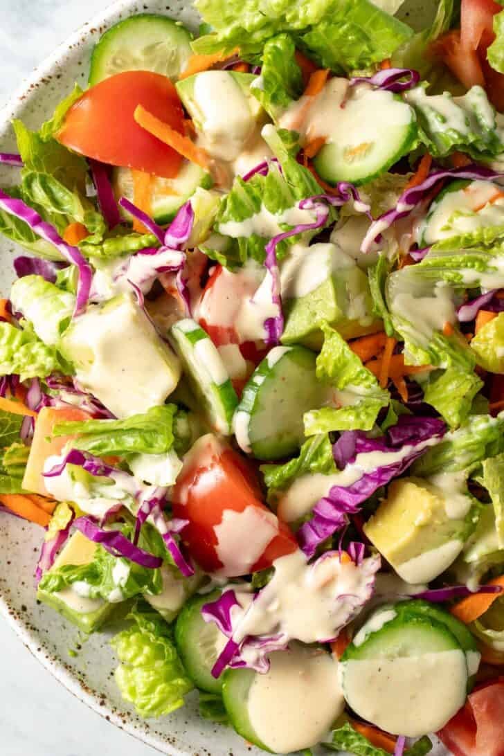 A white plate filled with fresh Garden Salad.