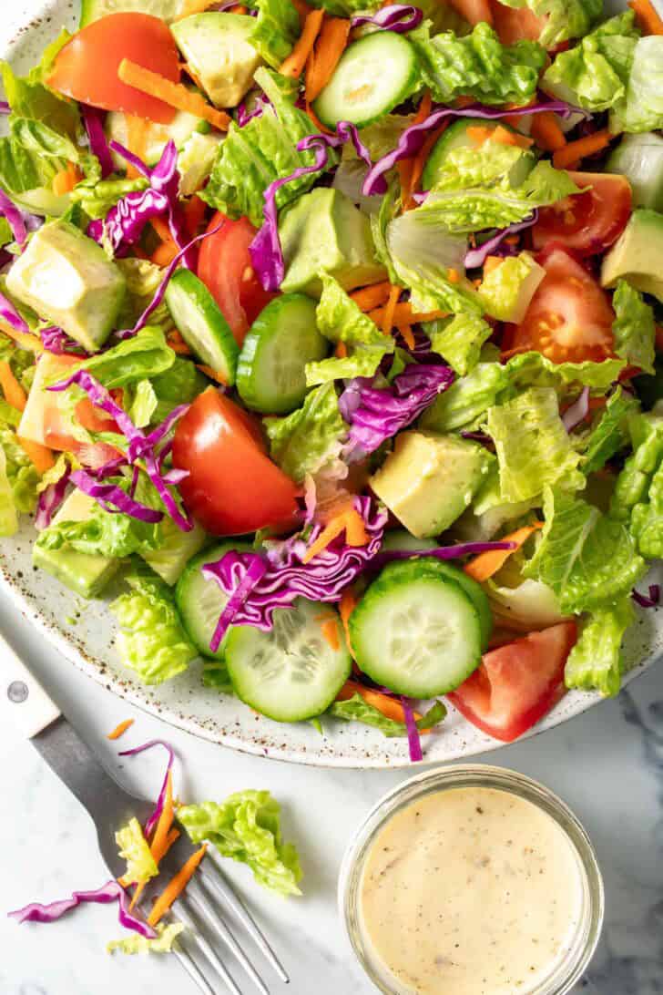 A white plate filled with the best Garden Salad.