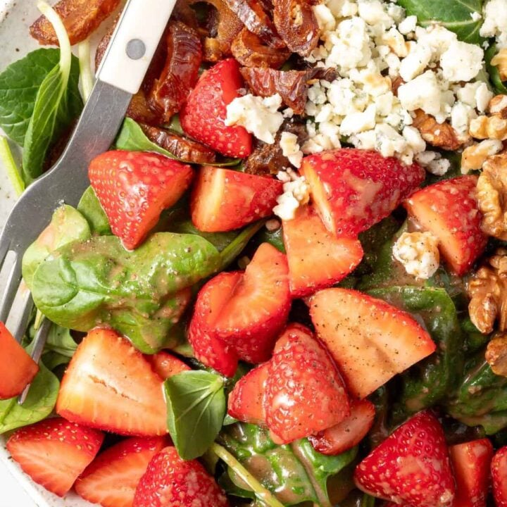 A white plate filled with Strawberry Spinach Salad.