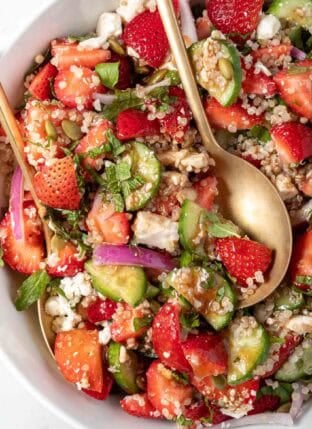 A white bowl filled with Strawberry Quinoa Salad.