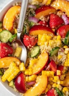 A white bowl filled with Summer Quinoa Salad.