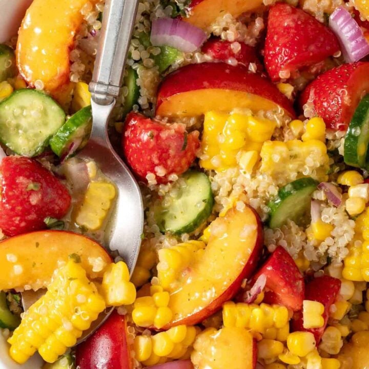 A white bowl filled with Summer Quinoa Salad.