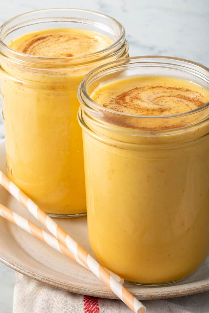 Mango Lassi in a clear drinking glass.