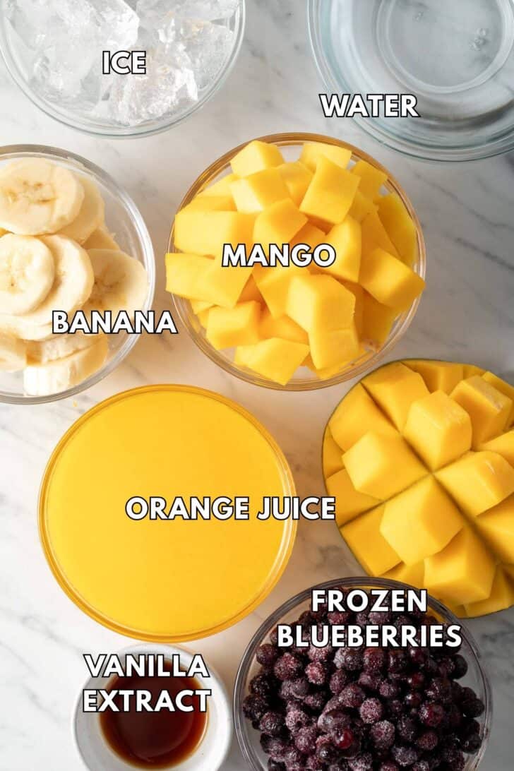 Clear glass bowls filled with fruit, juice, ice and water.