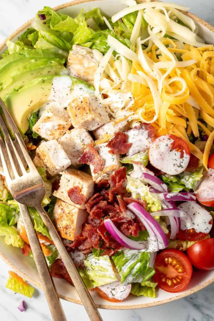 Chicken Bacon Ranch Salad in a bowl with two forks.