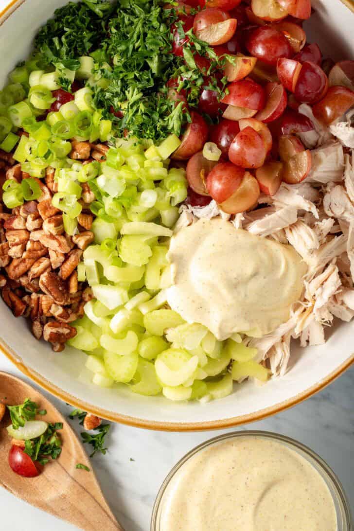 Curried Chicken Salad recipe ingredients in.a bowl.