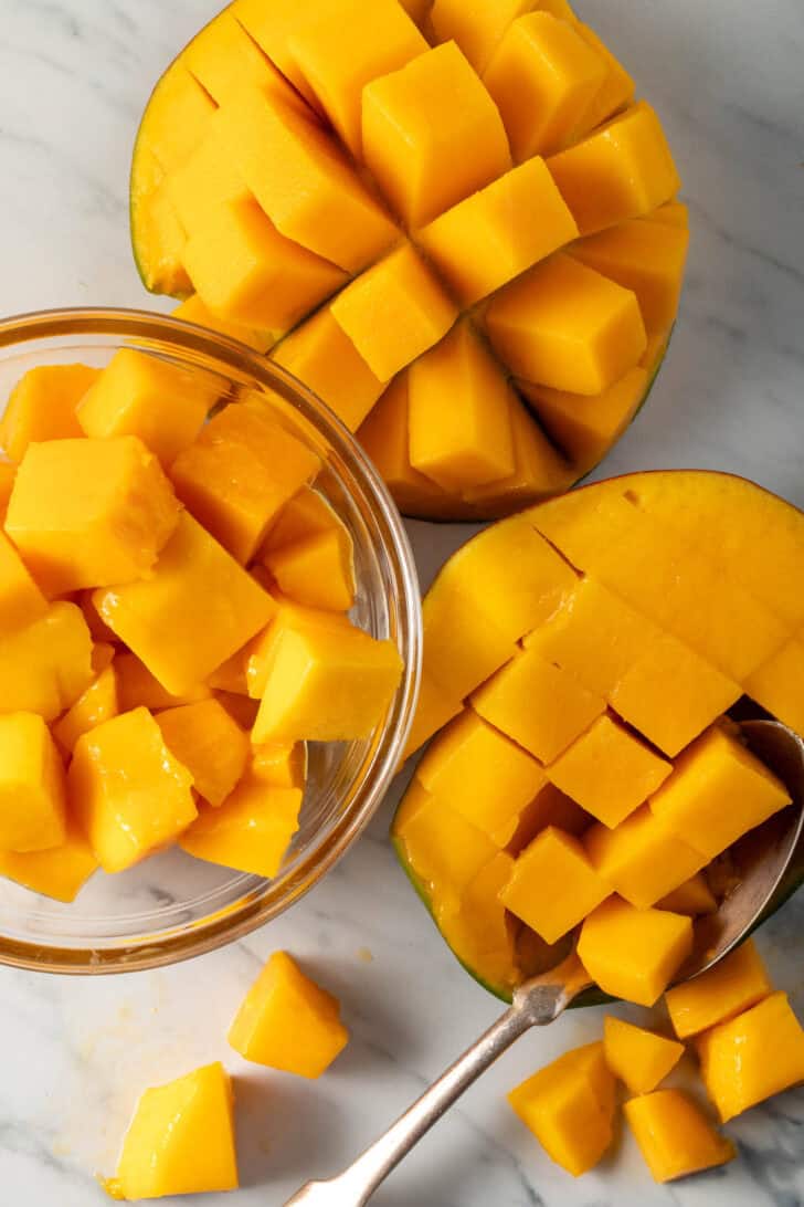 Chopped mango in a glass bowl.