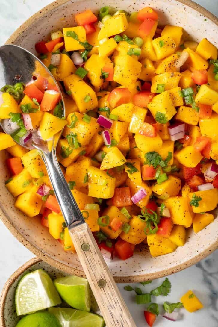 Mango Salsa in a bowl with a spoon.