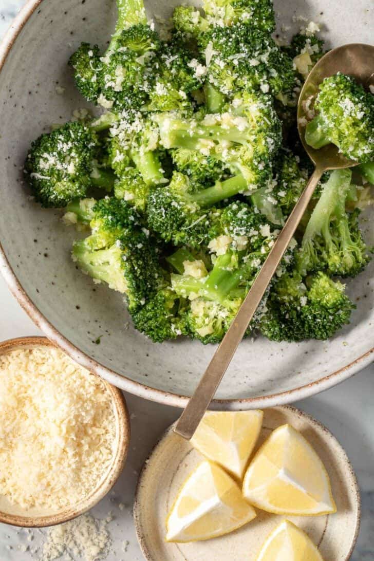 Steamed Broccoli in a bowl with a spoon.