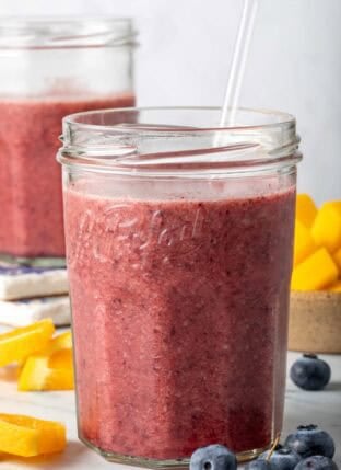 Mango Blueberry Smoothie in two clear drinking glasses.
