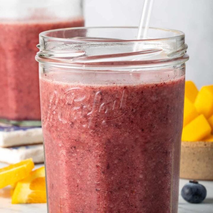 Mango Blueberry Smoothie in two clear drinking glasses.
