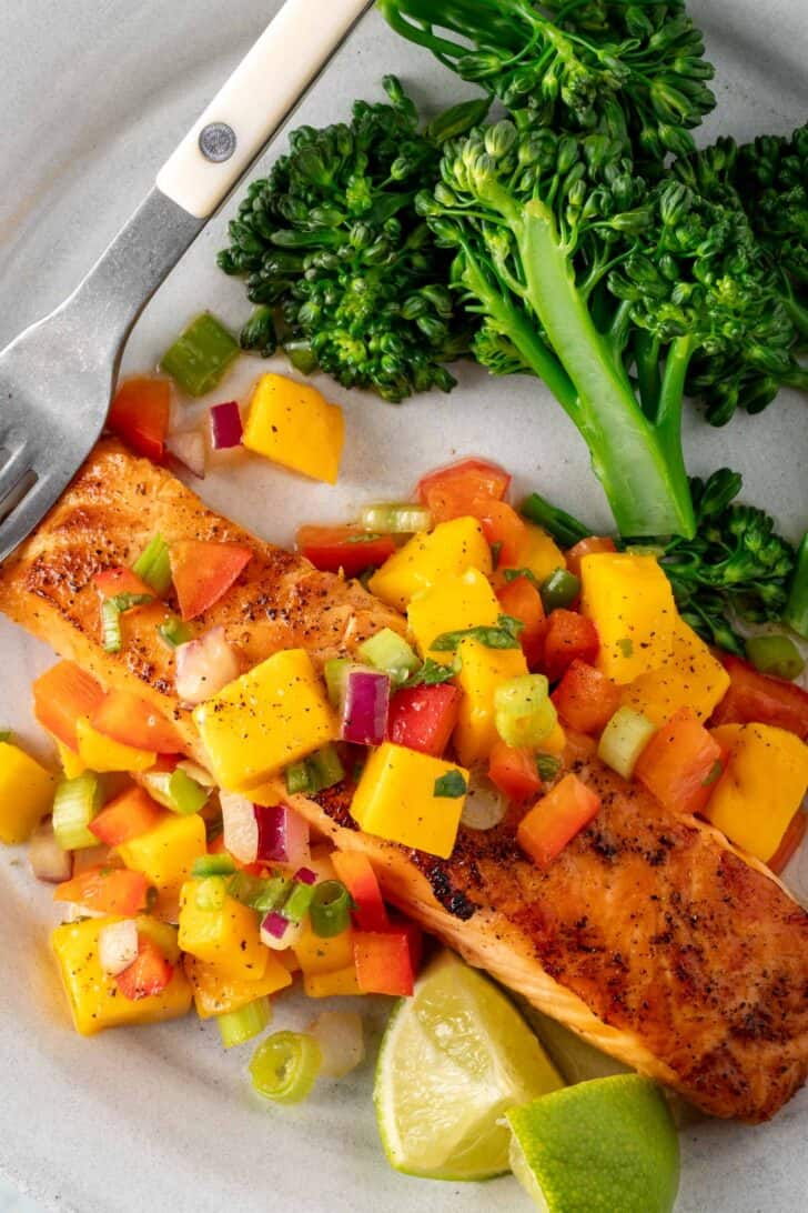 Broiled Salmon with Mango Salsa on a white plate.