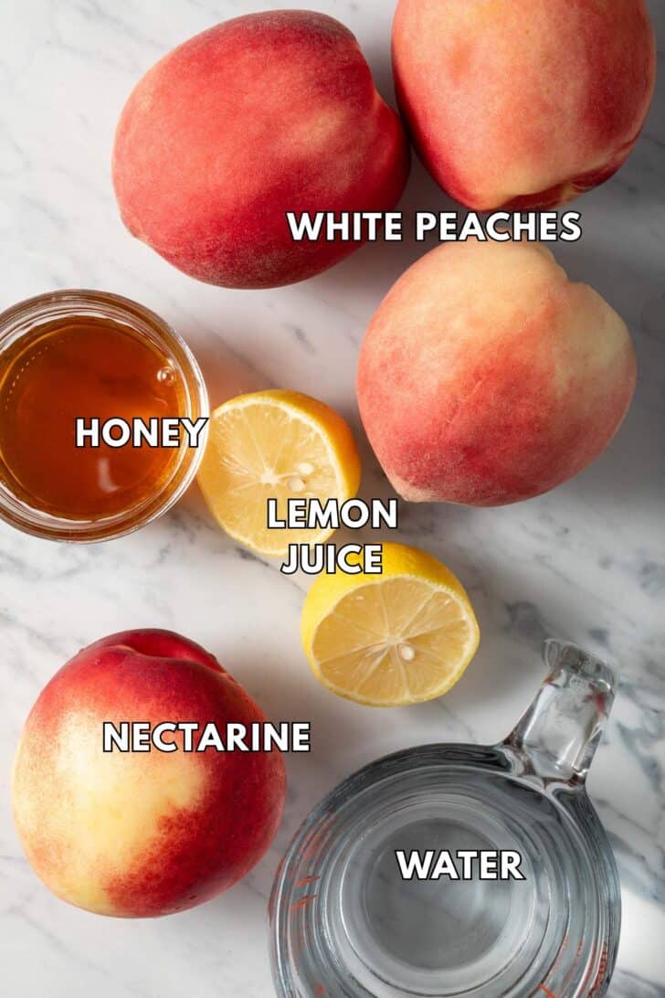 Peaches and nectarines on a cutting board.
