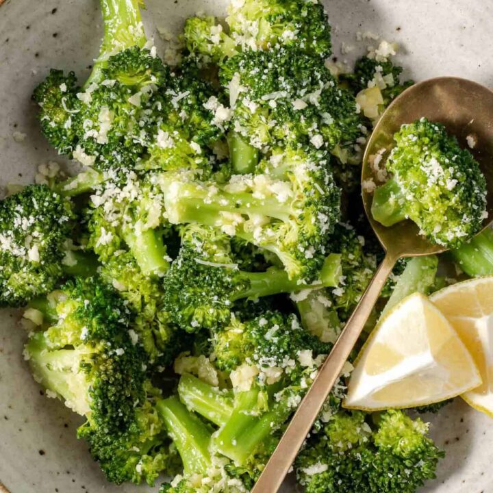 Steamed Broccoli in a bowl with a spoon.