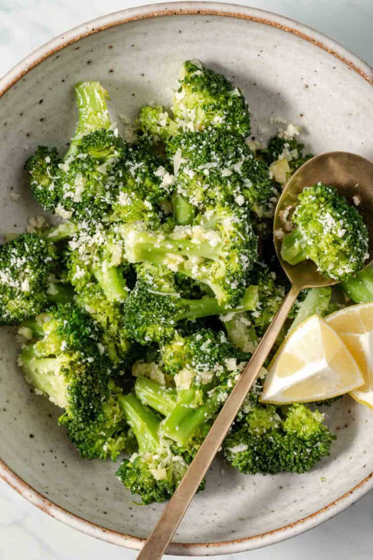 Steamed Broccoli in a bowl with a spoon.
