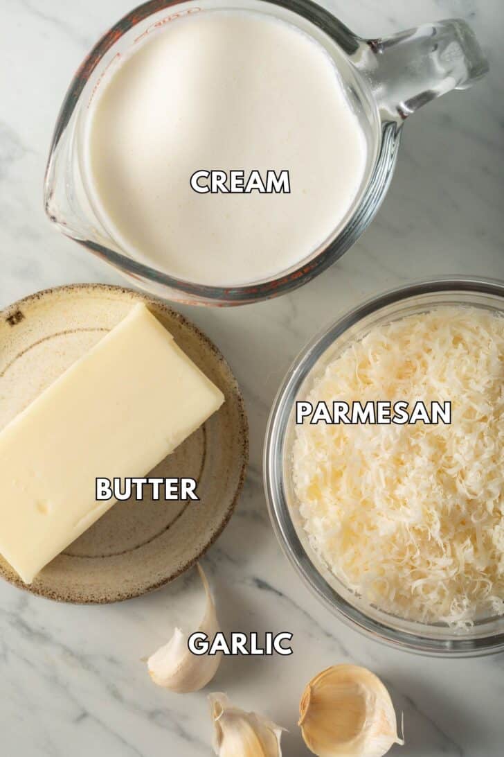 Class bowls with heavy cream, grated Parmesan cheese and butter.
