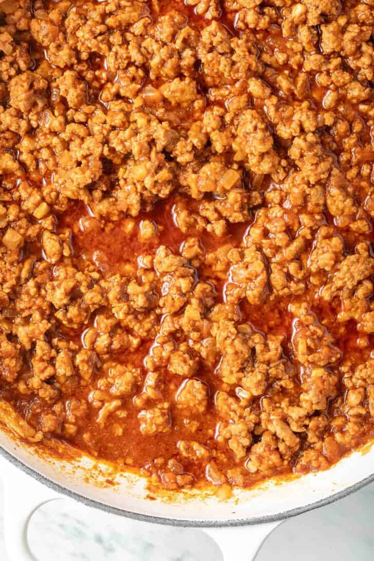 Ground turkey taco meat in a white skillet.
