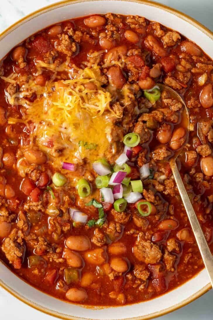 Turkey Chili in a white bowl with a spoon.