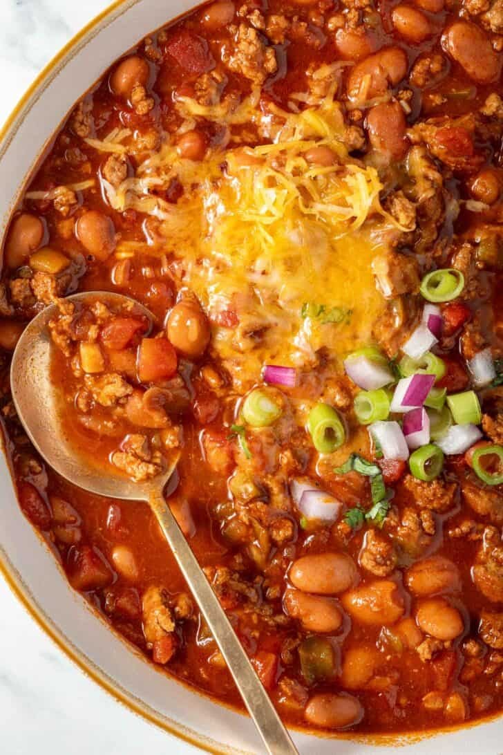 Ground Turkey Chili in a white bowl with a spoon.