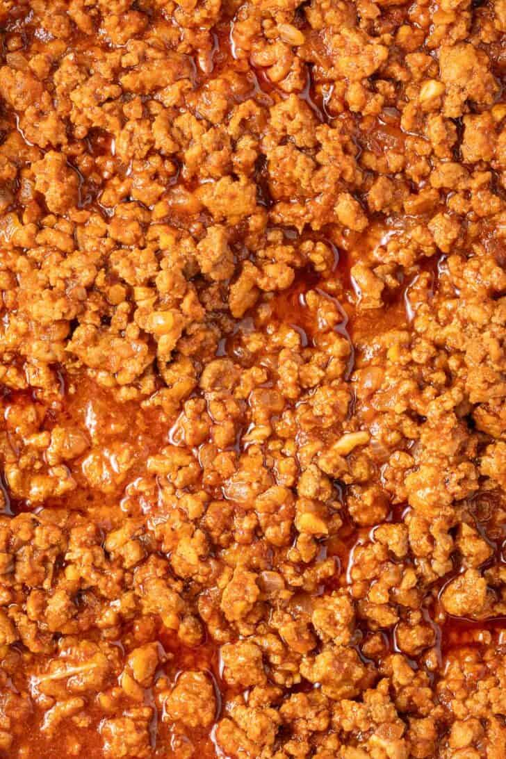 Ground taco meat in a white skillet.