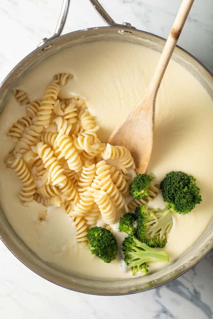 Chicken Broccoli Alfredo Recipe Alfredo Sauce in a Saucepan with pasta and broccoli.