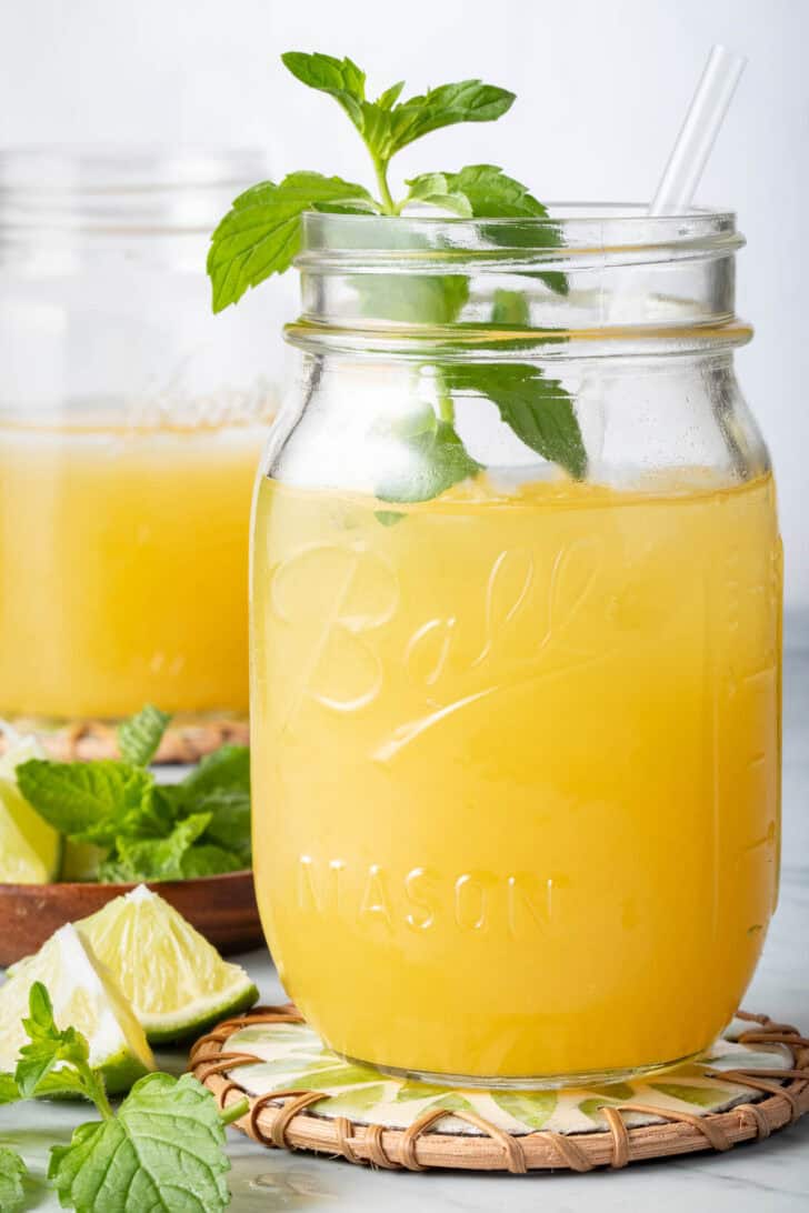 Mango Tea in a clear glass mason jar.