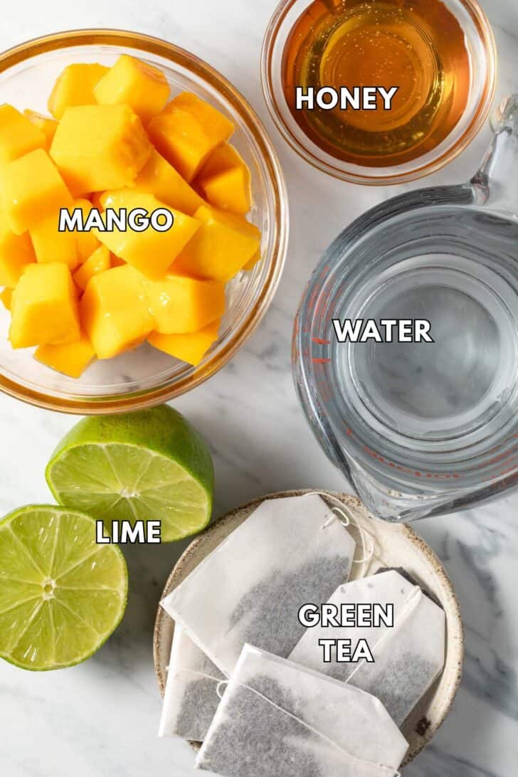 Clear glass bowls filled with chopped fruit, honey and water.