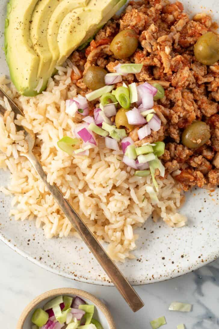 Turkey Picadillo with white rice on a plate.