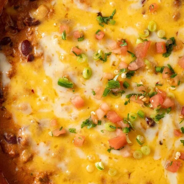 Chili Cheese Dip in a white skillet.