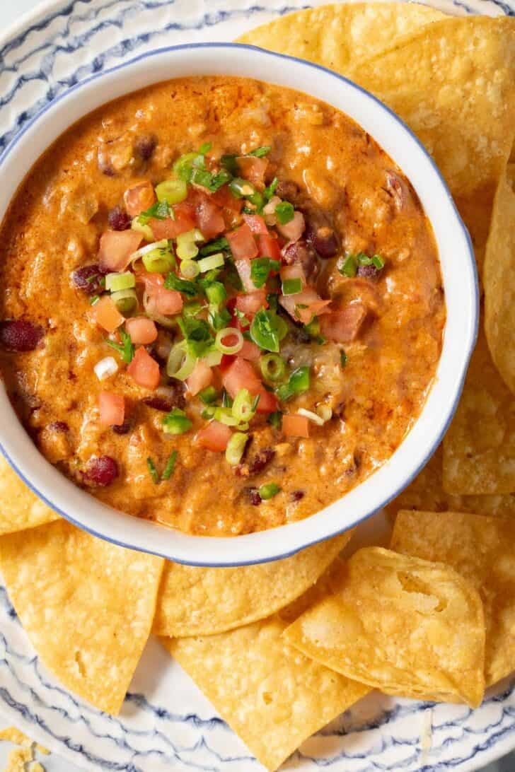 Chili Cream Cheese Dip in a bowl next to tortilla chips.