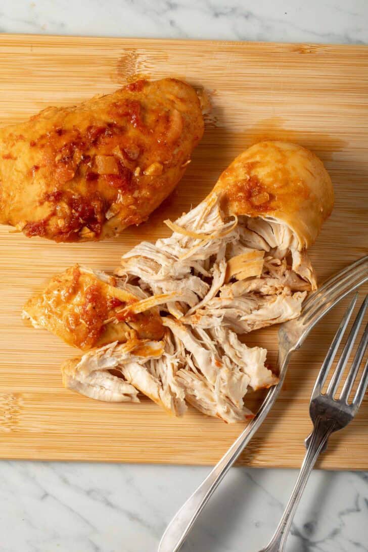 Mexican Pulled Chicken Mexican Pulled Chicken on a cutting board.