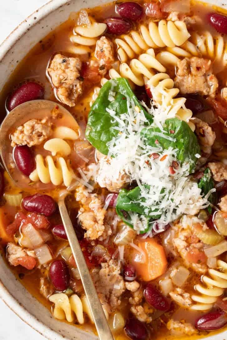 Italian Sausage Soup Italian Sausage Soup in a bowl with a golden spoon.