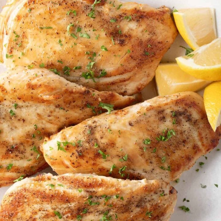 Pan Seared Chicken Breasts on a white plate.