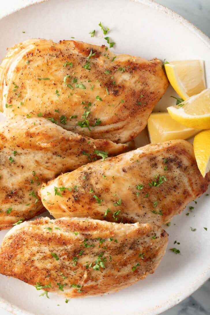 Pan Seared Chicken Breast Pan Seared Chicken Breast on a white plate.