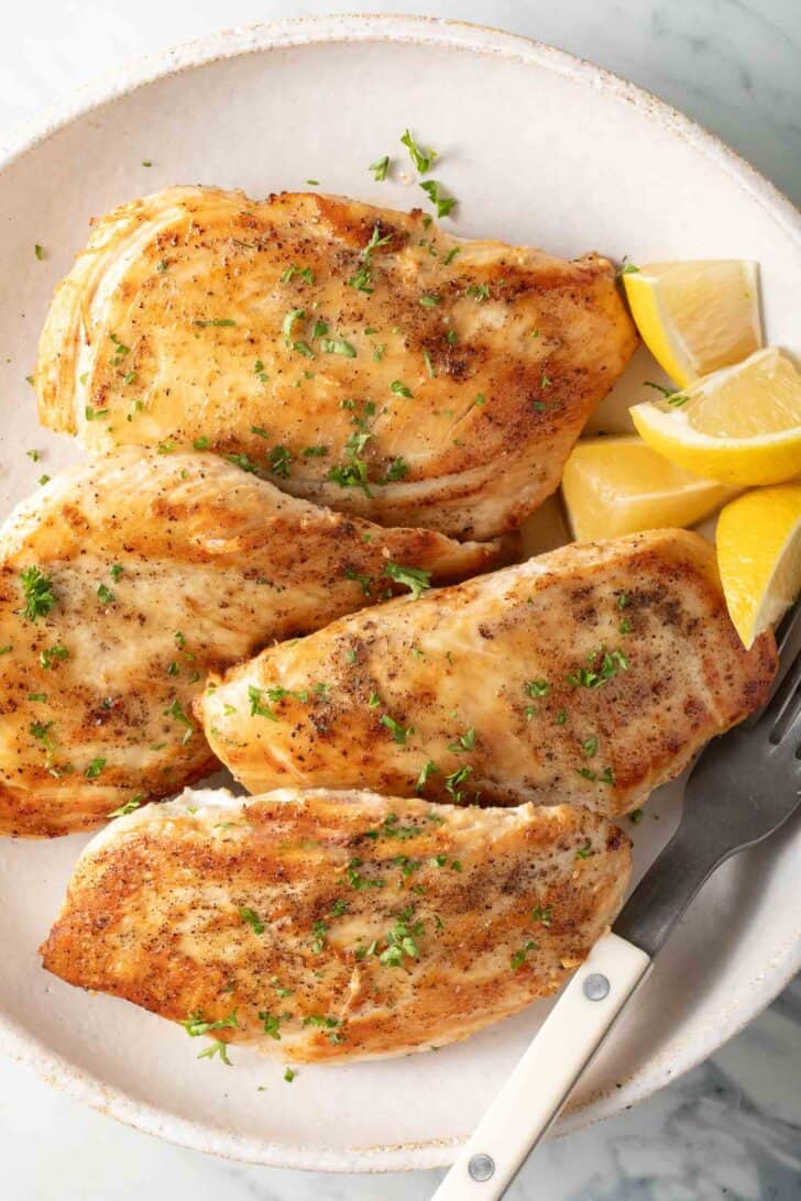 Pan Searing Chicken Breast Pan Seared Chicken Breasts on a white plate.