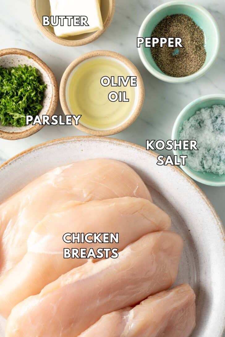 Pan Seared Chicken Breast Raw chicken breasts on a plate.