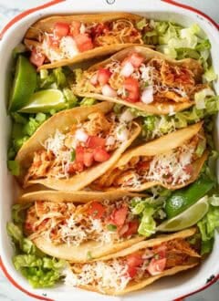Shredded Chicken Tacos on a white tray.