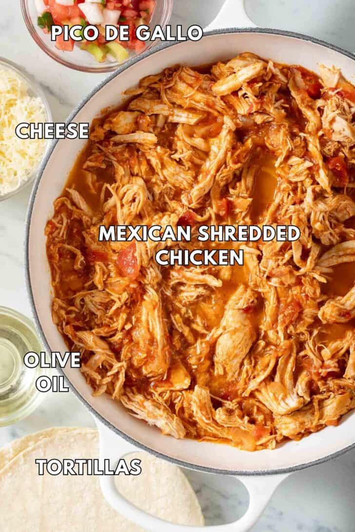 Shredded chicken in a white pot.