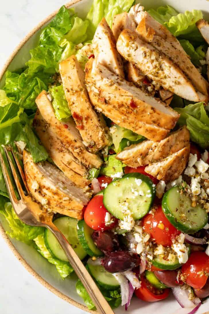 Greek Salad with Chicken Greek Salad with Chicken in a bowl with a fork.