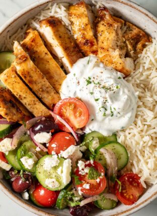 Greek Chicken Bowl (with marinated chicken, cucumber salad, Basmati rice and yogurt dill sauce).