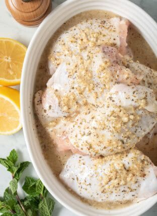 Greek Chicken Marinade in a white bowl.