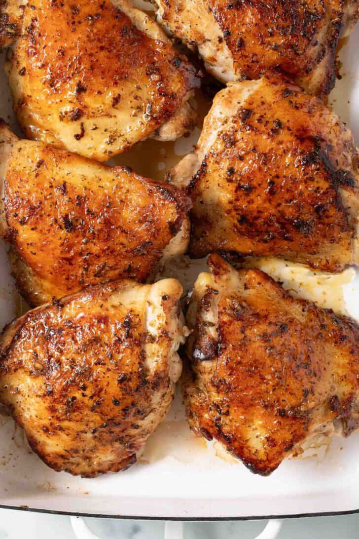 Greek Marinated Chicken Greek Marinated Chicken in a white baking dish.
