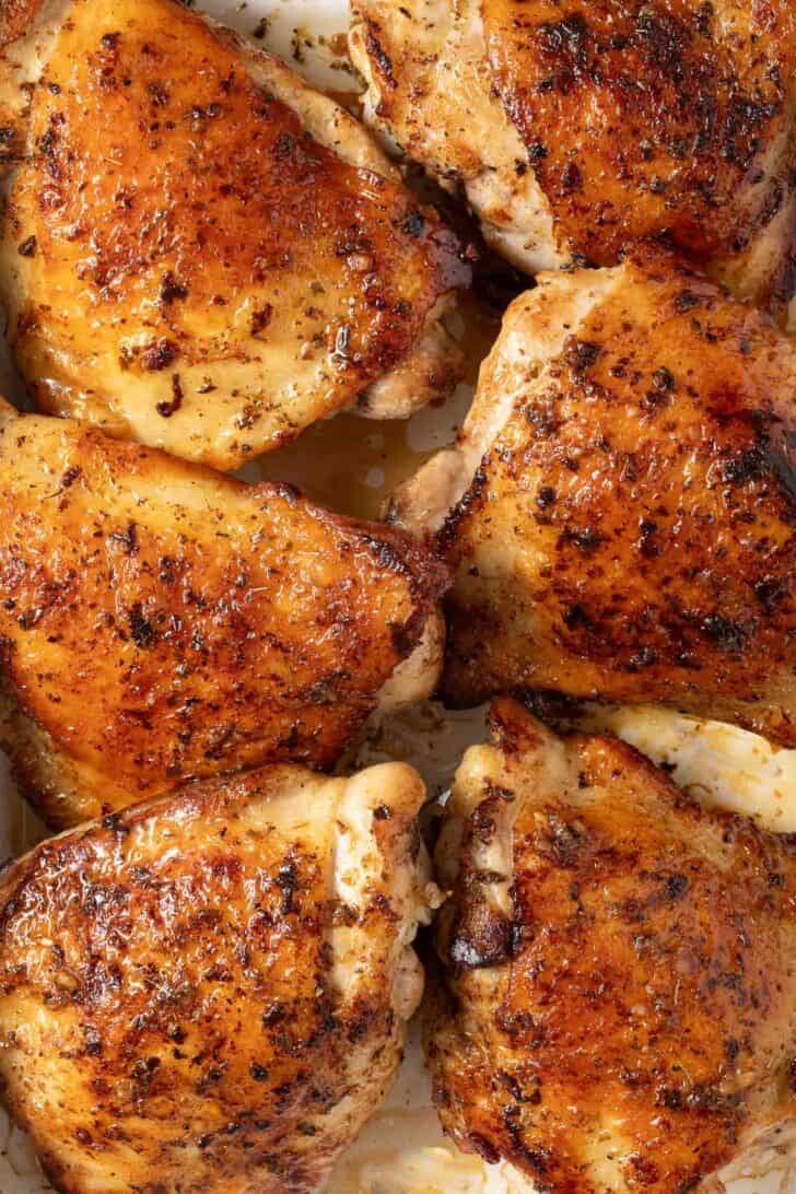 Greek Marinade for Chicken Marinated Greek Chicken Thighs in a white baking dish.