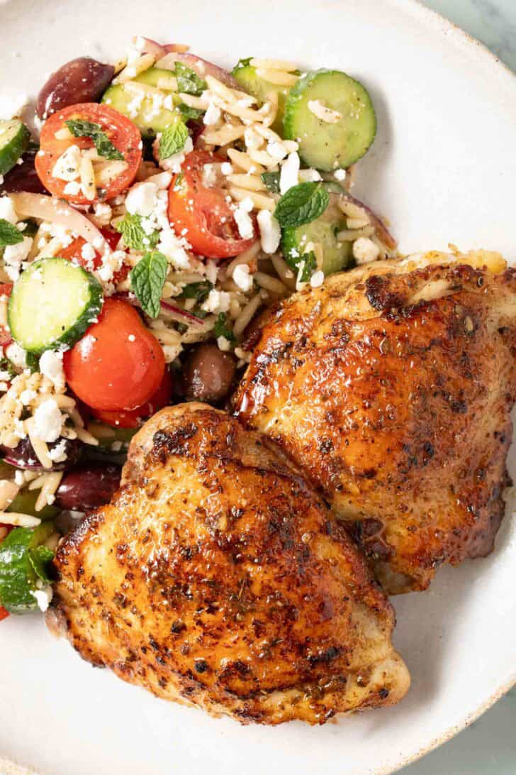 Marinated Greek Chicken Marinated Greek Chicken on a plate with salad.