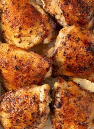 Marinated Greek Chicken in a white baking dish.
