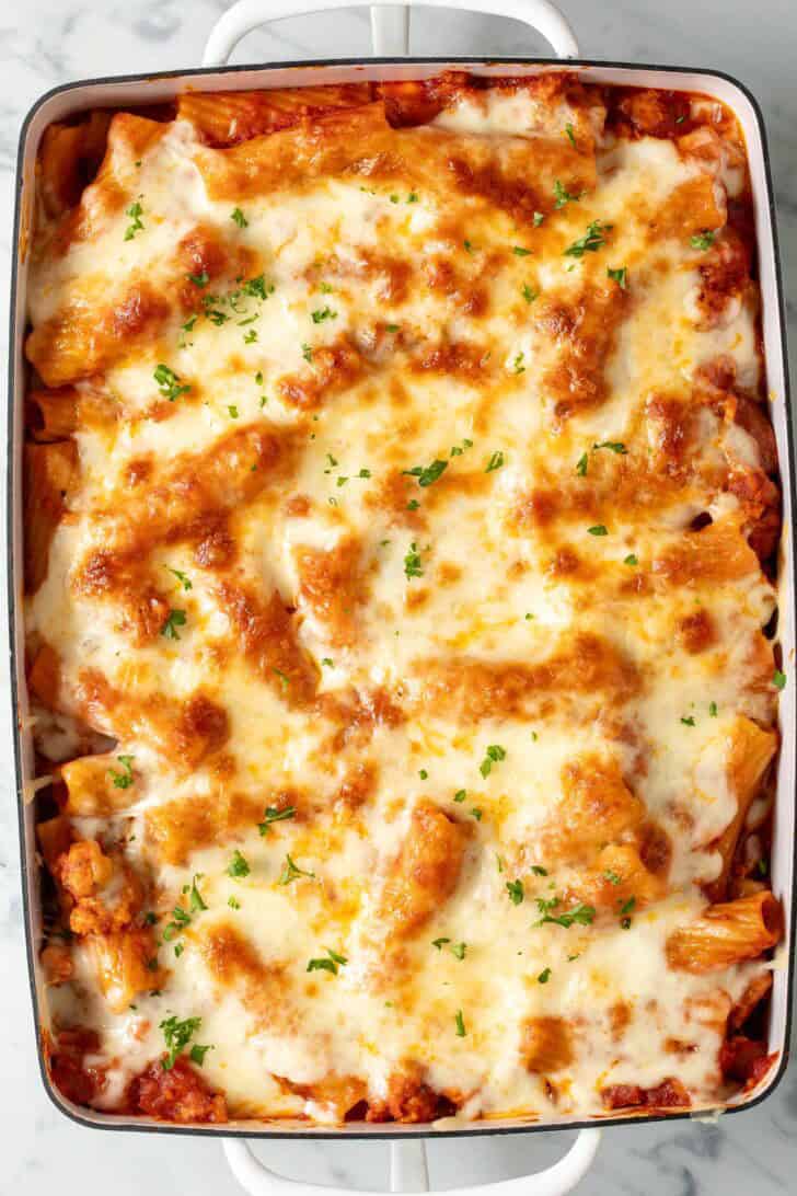 Rigatoni Bake with Sausage Rigatoni Bake with Sausage in a white baking dish.