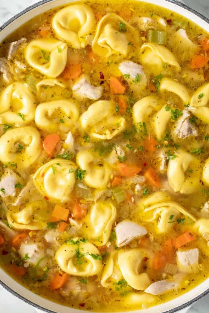 Chicken and Tortellini Recipe Chicken and Tortellini Soup in a white pot.